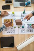 Architects and engineers discuss how to design  housing estate to ensure construction is up to standard and completed on time. team of engineers and architects discuss building design and structure. photo