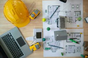 Construction engineers place plans and model homes  on desks in their offices for real estate agents to view the plans they want construction engineers to build on budget and meet client needs. photo