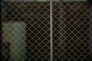 Steel mesh is used as temporary fence to mark boundaries of private property because it is durable and easy install as fence. steel mesh background is installed to prevent intrusion and has copy space photo
