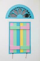 vintage arched wooden windows are painted in beautiful colors and are designed with bright colors on background. Bright rainbow colored windows are design on white background because they are popular. photo