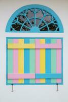 vintage arched wooden windows are painted in beautiful colors and are designed with bright colors on background. Bright rainbow colored windows are design on white background because they are popular. photo