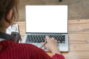 Image of female hand using and touching on laptop touchpad with blank white desktop screen. photo