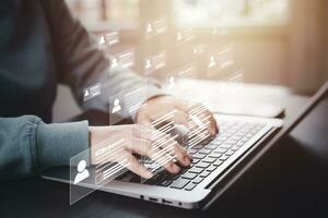 Businessman using laptop with Online documentation database, complete the online survey form, answer the test questions. Marked checklist on a clipboard. Human resources and management concept. photo