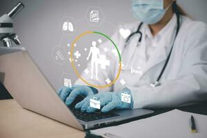 Medical doctor and medical technology and futuristic concept, Doctor using laptop and health medical network connection icon on virtual screen interface, Modern medical technology and innovation. photo