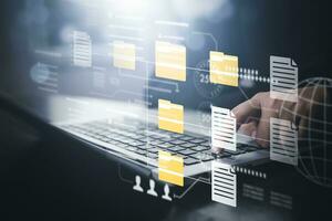 Document Management System DMS, set up by IT consultant working on a digital tablet and laptop computer in the office. Software for archiving, searching and managing corporate files and information photo