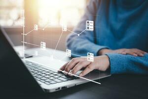 Businesswoman working on laptop with virtual screen. Online documentation database, IT consultant being set up Virtual Document Management System with a laptop, Software for archiving corporate files. photo