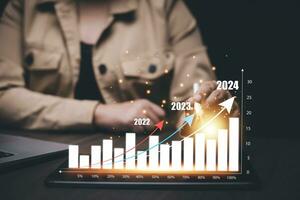 Business planning and  Happy New Year 2024 with chart graph Analytical businessman planning business growth 2024, strategy digital marketing, Planning, challenge strategy business in 2024 Concept. photo