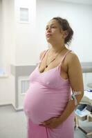 Birthing mother giving birth to child in the hospital delivery room. Pregnancy. Obstetrics. Gynecology. Healthcare photo