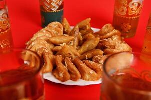 Soft focus on tasty and sweet plate full of fresh traditional Moroccan handmade Brewat sweets. Arabic traditional oriental sweets on the festive table photo