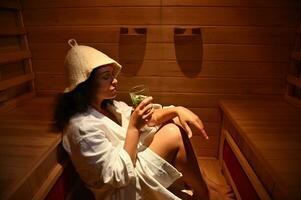 Woman resting in infrared sauna. SPA resort treatment. Beauty therapy concepts photo