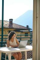 Confident young woman, entrepreneur freelancer working on laptop from her terrace at home. People. Business. Startup photo