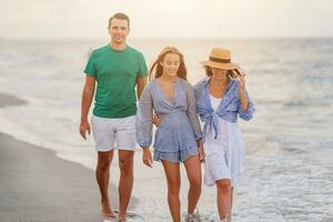 Happy family on the beach during summer vacation photo