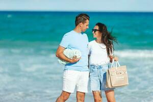 Young couple on white beach during summer vacation photo