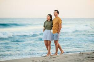 Young couple spending time together on the beach photo