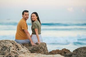 Young couple on the beach vacation in Florida at sunset photo