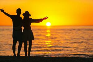 Young couple in love on the beach summer vacation. Happy man and woman enjoy time together photo