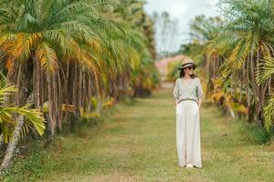 Young woman by palm trees photo