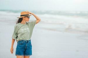 Young happy woman walking on the beach photo