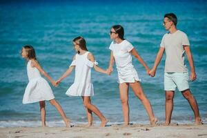 Happy family on the beach during summer vacation photo