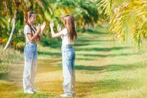 Beautiful teen girls having fun together on summer tropical vacation photo