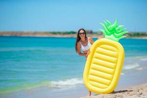 Young woman in swimsuit on the beach vacation ready to swim photo