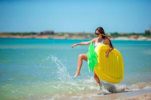 Young woman splashing in waves on the beach photo