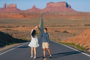 Happy couple on the famous road to Monument Valley in Utah. Amazing view of the Monument valley. photo