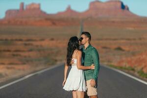 Happy couple on the famous road to Monument Valley in Utah. Amazing view of the Monument valley. photo