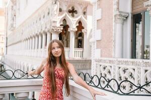 Beautiful young girl background the famous hotel in Las Vegas, standing in the busy city. Famous tourist attraction in USA on vacation in Las Vegas. photo