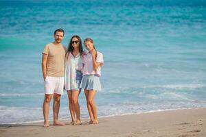 Portrait of family of three on the beach photo