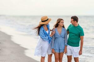 Happy family on the beach during summer vacation photo