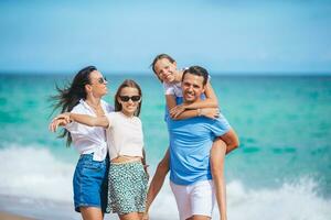 Family of four have fun together on beach vacation on Caribs photo