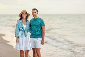 Young couple on white beach during summer vacation. photo