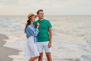 Young couple on white beach during summer vacation photo