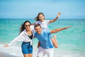 Family of three on the beach having fun together photo