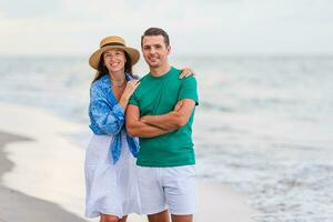 Young couple on white beach during summer vacation. photo