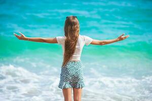 Happy young girl enjoy tropical beach vacation photo