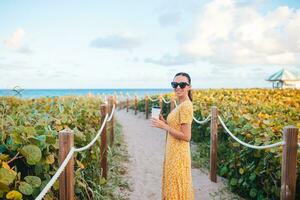 Young happy woman walking on the beach photo