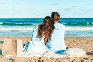 Young couple on white beach during summer vacation photo