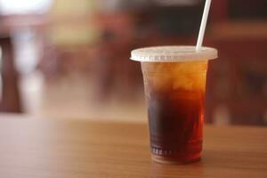 sweet iced tea on a wooden table with a blurred background. photo