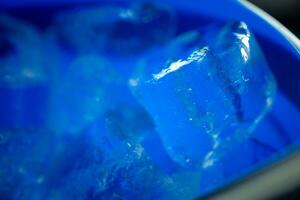 Blue plastic bucket with ice cubes photo