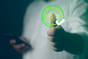 Fingerprint scan icon on visualizer screen to monitor when employees start work. HR technology in office photo