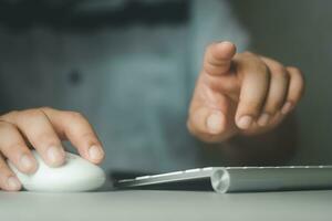 Businessman using computer mouse and pressing button on virtual screen. Man pointing. photo
