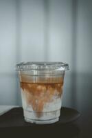 Cup of the dirty coffee menu, layer separation of espresso and milk. photo