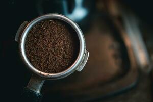 Coffee grounds in portafilter for shot espresso photo