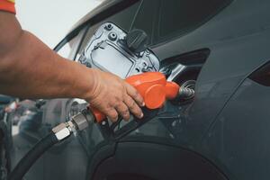 Handle fuel nozzle to refuel the car. photo