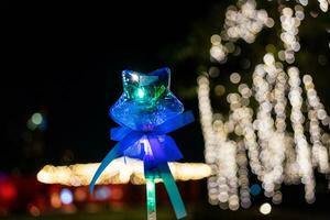 Colorful star shape light stick in hand with light on a bokeh background photo