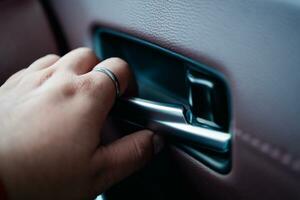 Man press the button open luxurious car door from inside photo