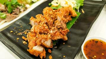 Street cuisine from Thailand with crispy pork and traditional sauce photo