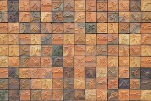 The brick wall of the building where each brick has a picture depicting a different sport. photo